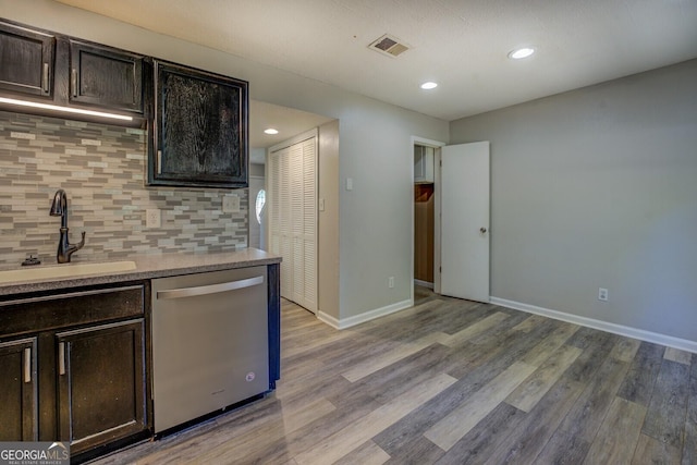 302 Atlanta Ave SE, Atlanta, GA 30315 - kitchen featuring stainless steel dishwasher, a sink, light wood-type flooring, dark brown cabinets, and decorative backsplash