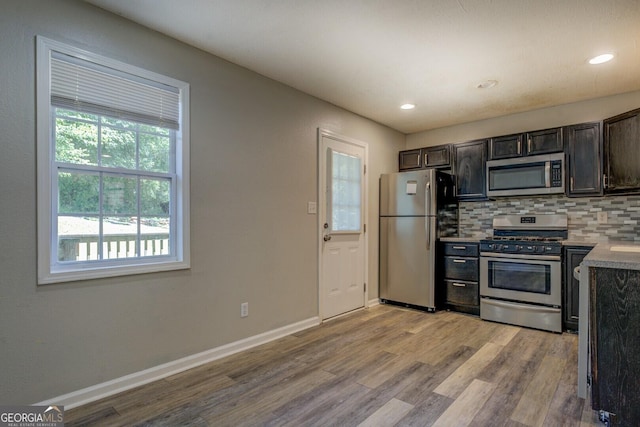 302 Atlanta Ave SE, Atlanta, GA 30315 - kitchen with stainless steel appliances, light wood-style floors, backsplash, baseboards, and recessed lighting