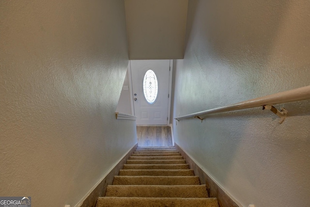 302 Atlanta Ave SE, Atlanta, GA 30315 - stairway featuring wood finished floors, a textured wall, and baseboards