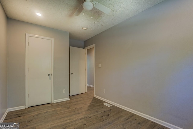 302 Atlanta Ave SE, Atlanta, GA 30315 - unfurnished bedroom with wood finished floors, baseboards, a ceiling fan, a textured ceiling, and recessed lighting