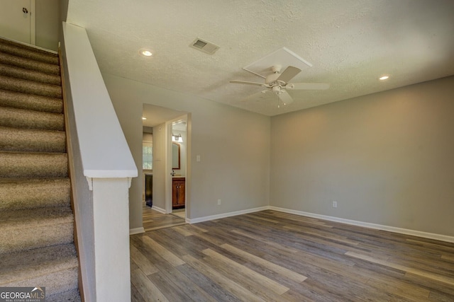 302 Atlanta Ave SE, Atlanta, GA 30315 - empty room with ceiling fan, stairs, wood finished floors, baseboards, and a textured ceiling
