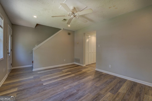 302 Atlanta Ave SE, Atlanta, GA 30315 - spare room featuring wood finished floors, a textured ceiling, stairway, a ceiling fan, and baseboards