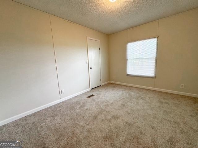 140 Holiday Rd, Franklin, GA 30217 - unfurnished room featuring a textured ceiling, carpet, and baseboards