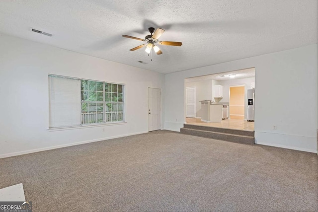 2907 Oakvale Falls Dr, Decatur, GA 30034 - spare room featuring light carpet, a ceiling fan, baseboards, and a textured ceiling