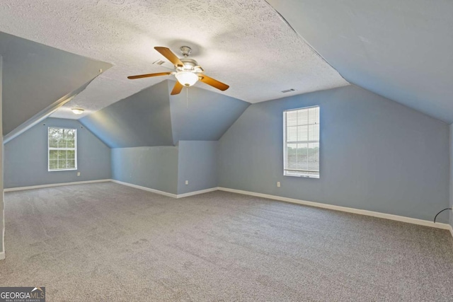 2907 Oakvale Falls Dr, Decatur, GA 30034 - additional living space featuring carpet flooring, baseboards, vaulted ceiling, ceiling fan, and a textured ceiling