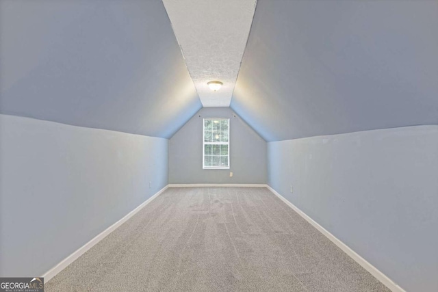 2907 Oakvale Falls Dr, Decatur, GA 30034 - additional living space with vaulted ceiling, baseboards, and carpet