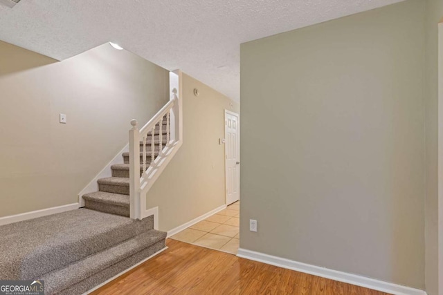 2907 Oakvale Falls Dr, Decatur, GA 30034 - stairs with baseboards, wood finished floors, and a textured ceiling