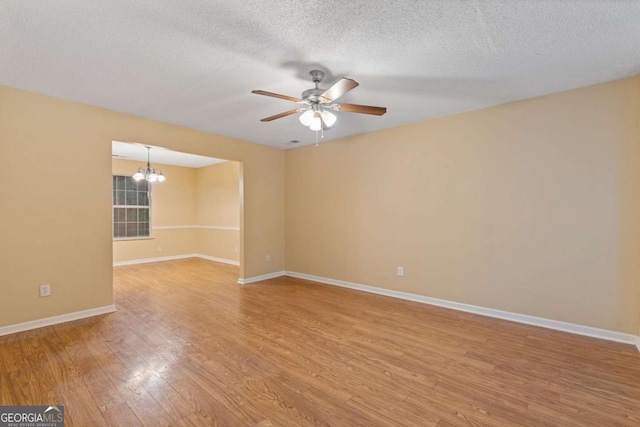 2907 Oakvale Falls Dr, Decatur, GA 30034 - spare room with a chandelier, a ceiling fan, light wood-style floors, a textured ceiling, and baseboards