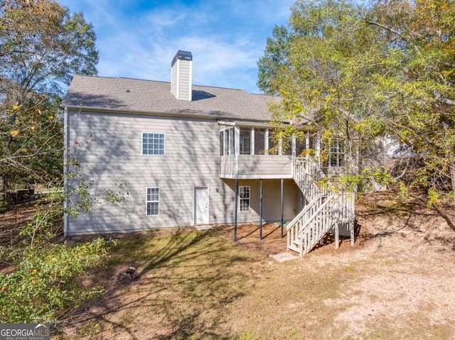 1151 Emperor Ln, Hoschton, GA 30548 - rear view of property featuring a chimney, a sunroom, stairs, a wooden deck, and a lawn