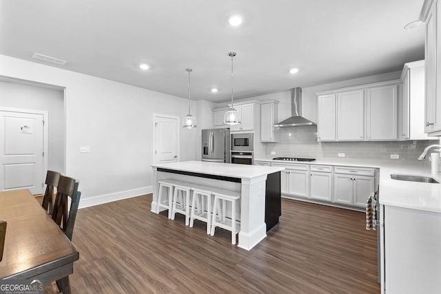 510 Cunninghame Ct, Peachtree City, GA 30269 - kitchen featuring a sink, stainless steel appliances, wall chimney range hood, a kitchen island, and light countertops