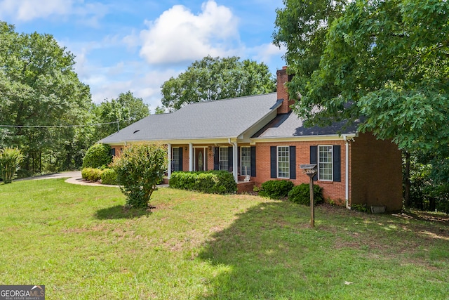 1112 Reno Rd, Royston, GA 30662 - view of front of house featuring brick siding, a front yard, and a chimney