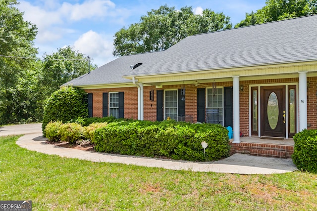 1112 Reno Rd, Royston, GA 30662 - view of front facade with roof with shingles, brick siding, a front yard, and a porch