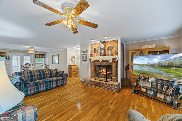 1112 Reno Rd, Royston, GA 30662 - living room featuring crown molding, ceiling fan, a fireplace, and wood finished floors