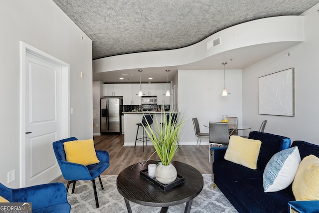 living area featuring wood finished floors and baseboards