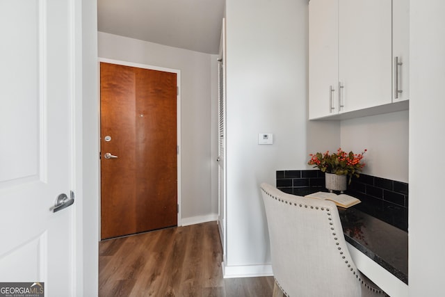 bathroom with wood finished floors and baseboards
