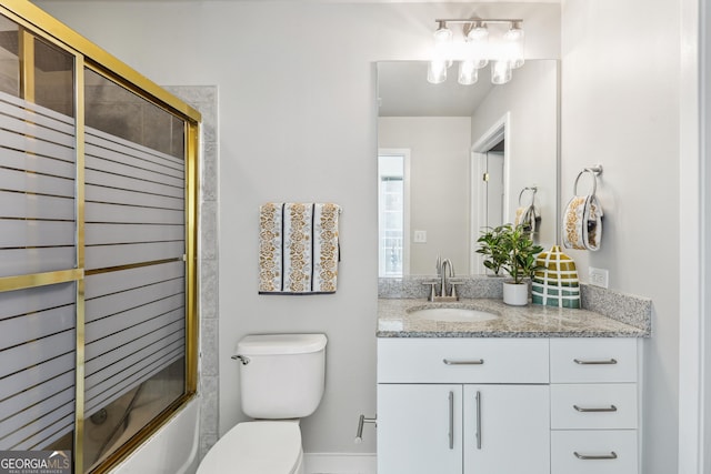 full bathroom featuring toilet, vanity, and bath / shower combo with glass door