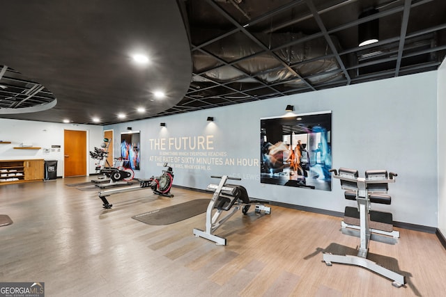 gym with wood finished floors, recessed lighting, and baseboards