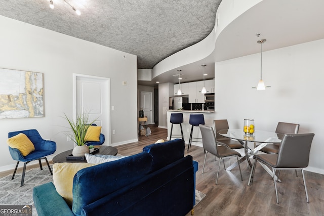 living area featuring wood finished floors and baseboards