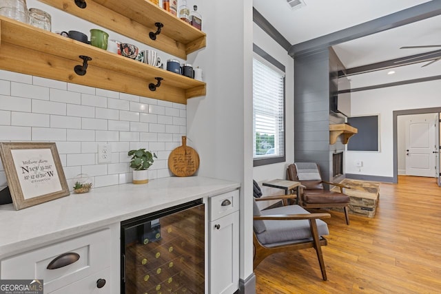 47 Wicklow Ct, Hoschton, GA 30548 - bar with beverage cooler, tasteful backsplash, and light wood-type flooring