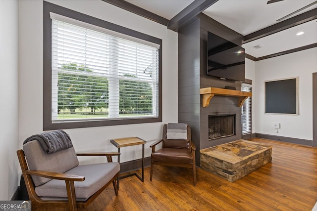 47 Wicklow Ct, Hoschton, GA 30548 - living area with wood-type flooring, healthy amount of natural light, a fireplace, recessed lighting, and crown molding