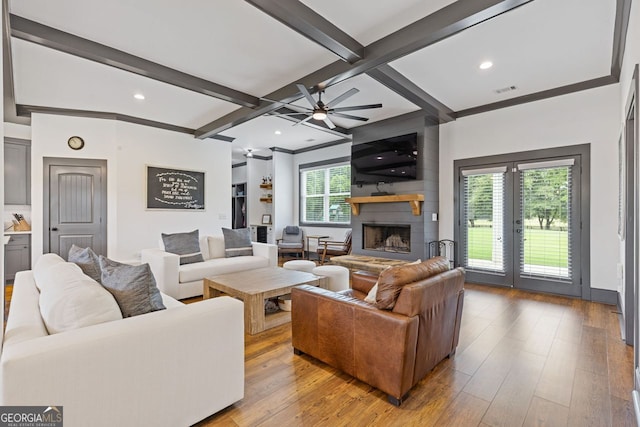 47 Wicklow Ct, Hoschton, GA 30548 - living room featuring a large fireplace, beamed ceiling, a ceiling fan, hardwood / wood-style flooring, and coffered ceiling