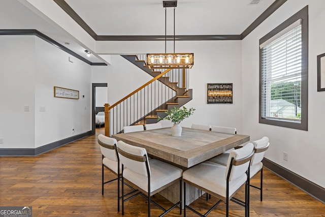 47 Wicklow Ct, Hoschton, GA 30548 - dining space with dark wood finished floors, stairs, a chandelier, and crown molding