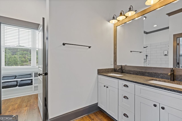 47 Wicklow Ct, Hoschton, GA 30548 - bathroom with double vanity, a tile shower, and wood finished floors