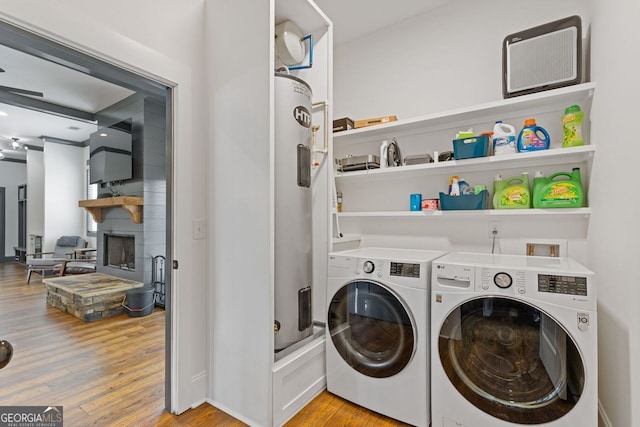 47 Wicklow Ct, Hoschton, GA 30548 - washroom with independent washer and dryer, light wood-style flooring, and a large fireplace