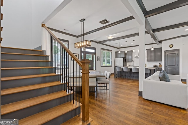 47 Wicklow Ct, Hoschton, GA 30548 - stairs with wood finished floors, crown molding, and a chandelier