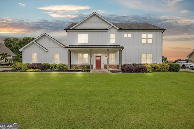47 Wicklow Ct, Hoschton, GA 30548 - view of front of property featuring a standing seam roof, a front lawn, board and batten siding, and a metal roof