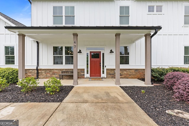 47 Wicklow Ct, Hoschton, GA 30548 - view of exterior entry with board and batten siding, covered porch, and stone siding