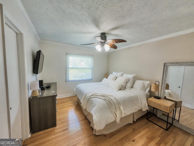 3905 Hunt Dr, Gainesville, GA 30507 - bedroom with light wood-style floors, ornamental molding, a textured ceiling, and a ceiling fan