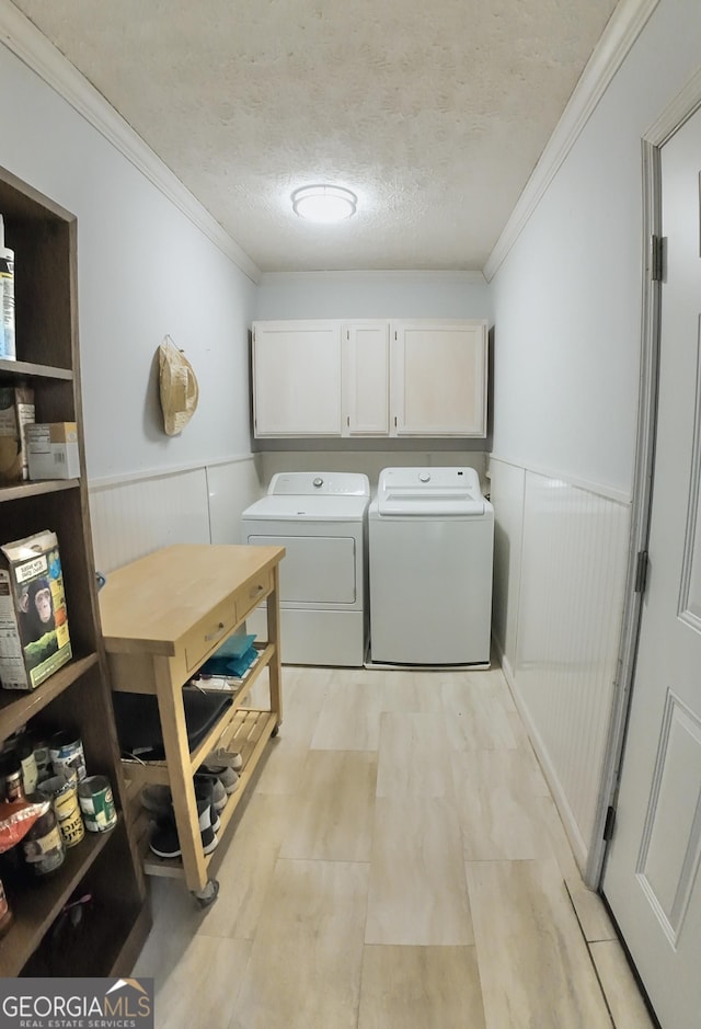 3905 Hunt Dr, Gainesville, GA 30507 - laundry room featuring washer and dryer, wainscoting, ornamental molding, cabinet space, and a textured ceiling