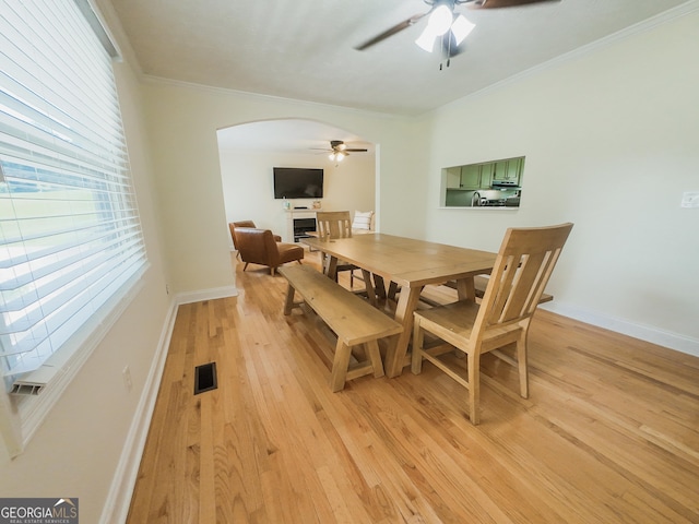 3905 Hunt Dr, Gainesville, GA 30507 - dining space with ceiling fan, arched walkways, light wood-style flooring, and crown molding