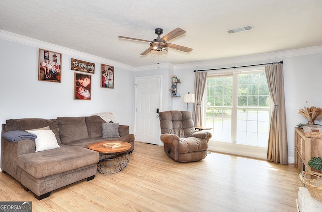 living area featuring a ceiling fan, wood finished floors, and crown molding