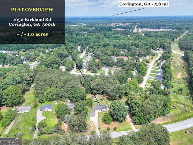 aerial view of property's location featuring a forest