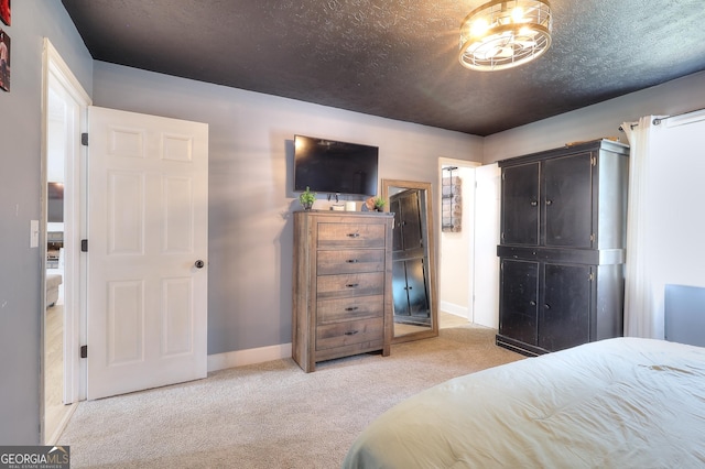 bedroom with light carpet and baseboards