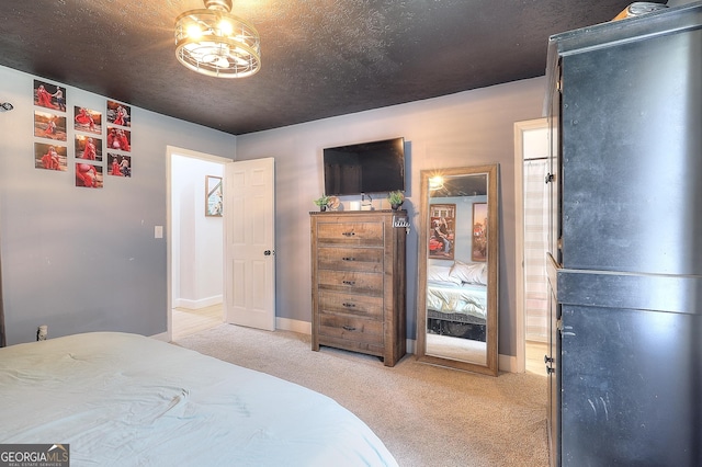 bedroom with light colored carpet and baseboards