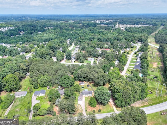 aerial view of property and surrounding area featuring a forest