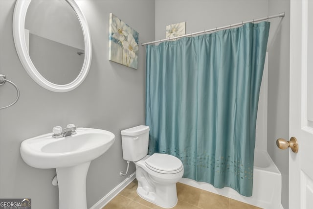 full bathroom featuring tile patterned flooring, toilet, baseboards, and shower / bath combination with curtain