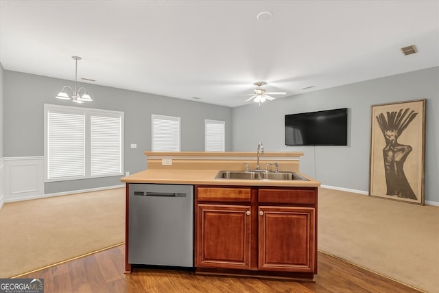 kitchen with stainless steel dishwasher, a sink, a ceiling fan, a chandelier, and carpet floors