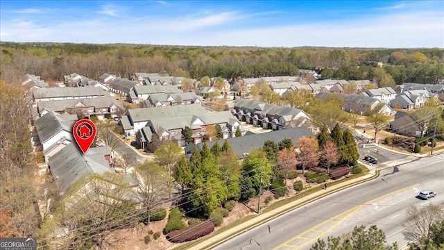 aerial perspective of suburban area featuring a heavily wooded area