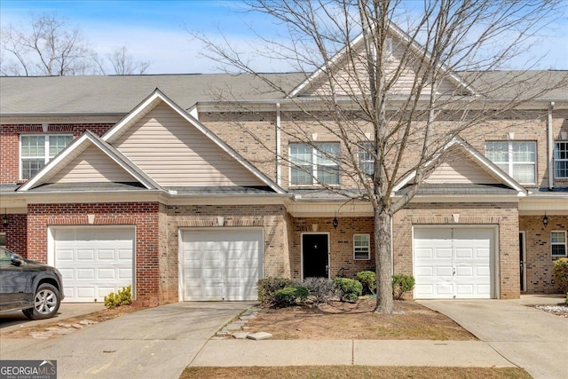 view of front of home with brick siding, driveway, and a garage