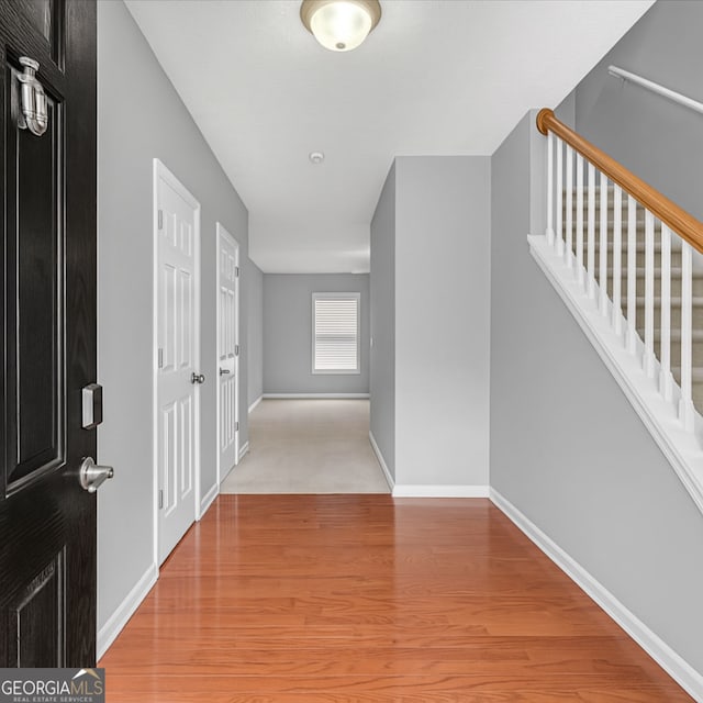 hallway with wood finished floors and baseboards