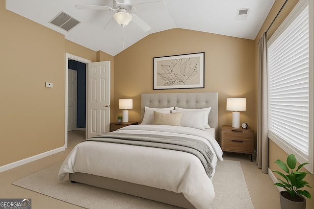 bedroom with light colored carpet, vaulted ceiling, baseboards, and ceiling fan
