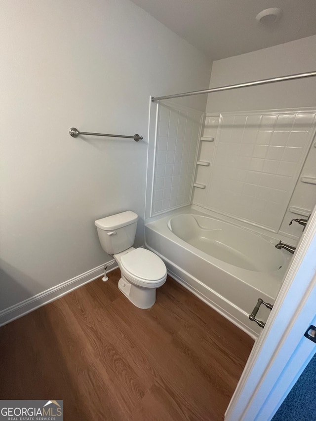 full bathroom with toilet, wood finished floors, baseboards, and shower / tub combination