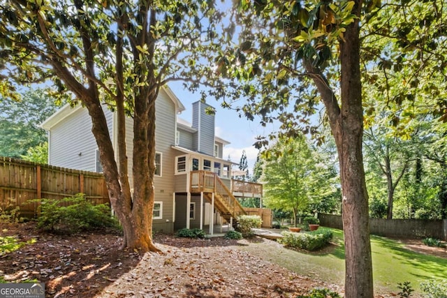 1811 Tilliewood Trl NE, Marietta, GA 30066 - back of house with stairs, a fenced backyard, a wooden deck, and a chimney
