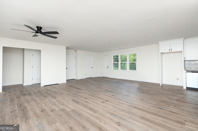 unfurnished living room featuring light wood-type flooring, a ceiling fan, and baseboards
