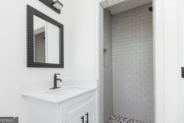 bathroom with a shower stall and vanity