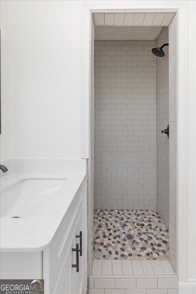 full bathroom featuring a shower stall and a sink